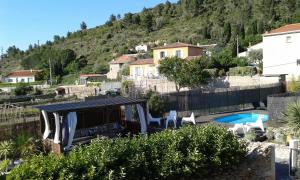 a villa with a swimming pool and a house at Au Paradis Cathare in Fraissé-des-Corbières