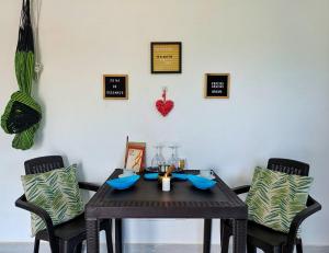 a dining room table with two chairs and a table with at Apartamento cerca a la playa in El Porvenir +20 photos