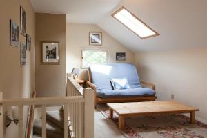 a living room with a blue chair and a table at Daisy's Place 30 day minimum in Hood River