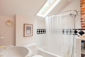 a bathroom with a white tub and a sink at Daisy's Place 30 day minimum in Hood River +15 photos