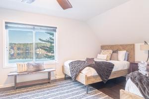 a bedroom with a large bed and a window at Lakefront Lookout- 14 S in Fort Ann