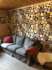a couch in a room with a wall of logs at Chalet Auhof in Flachau