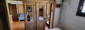 a room with some wooden cabinets in a room at Appartamento carciato dimaro in Dimaro