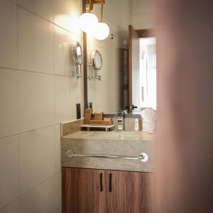 a bathroom with a sink and a mirror at Nöa Hotel in Piñas +31 photos