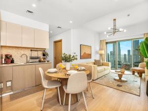 a kitchen and living room with a table and chairs at The Burj Khalifa Suite Luxury 2-bed in Burj Royale in Dubai