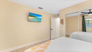 a bedroom with a bed and a view of a beach at The Shark Tank Cocoa Beach - Retro Florida, Downtown, 5-Min Walk to Beach, Shops & Bars in Cocoa Beach