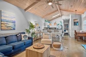 a living room with a blue couch and a table at Island Time in Port Aransas