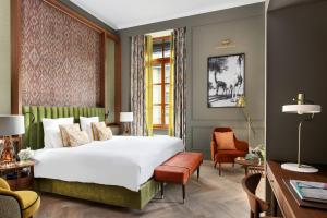 Ein Bett oder Betten in einem Zimmer der Unterkunft Hôtel Métropole Genève