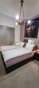 a bedroom with a large bed with a chandelier at THERESA DELUXE Italia in Cannobio