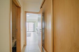 a bathroom with a door leading to a toilet and a sink at Mar e Arte in Olhão +21 photos