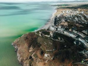 an aerial view of a beach and the ocean at The Marine Hotel in Criccieth