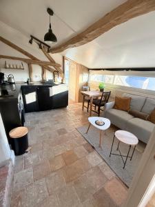 a living room with a couch and a table at La tour de l Horloge, appt typique à 500m du château in Chinon