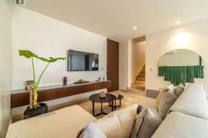 a living room with a couch and a table at 3BR Penthouse with Private Plunge Pool in Tulum