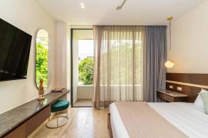 a hotel room with a bed and a large window at 3BR Penthouse with Private Plunge Pool in Tulum +64 photos
