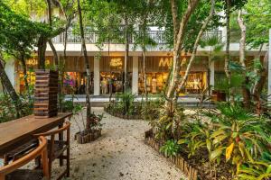 a park with a bench in front of a store at 3BR Penthouse with Private Plunge Pool in Tulum