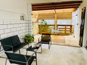 a living room with two chairs and a table at Lily House in Sainte-Marie