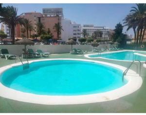 a large blue swimming pool on top of a building at Buganvilla 56 in Roquetas de Mar