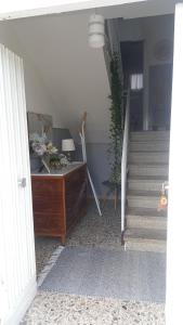 a stairway with a wooden dresser and stairs with a stair case at La casetta di Anna in Lanciano