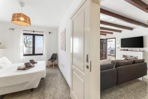 a bedroom and living room with a bed and a couch at Villa 3 VipVipVillas in Tías +18 photos