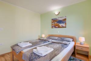 a bedroom with a bed with towels on it at Modernes Apartment mit Panoramablick, Pool - inmitten von historischem Zentrum in Pazin +29 photos