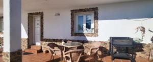a room with a table and chairs and a mirror at “Casa abella “ in La Magdalena
