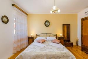 a bedroom with a bed with two pillows on it at Mediterranes Steinhaus mit grosser Terrasse, Aussendusche, Privatpool, Babybett, Waschmaschine in Grižane +32 photos