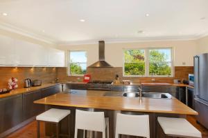 a kitchen with a wooden counter top and a sink at St Raphael in Leura