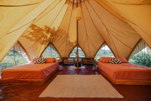 a room with two beds in a tent at Eco Luxe Glamping Tent - 2 Queen Beds at Holos in Barú