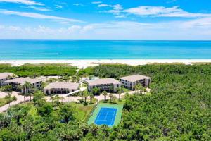 an aerial view of a resort with a tennis court and the beach at Sandpiper Beach 101 in Sanibel