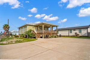 a large house with a deck on a driveway at Mills Fishing Cabin in Port Aransas