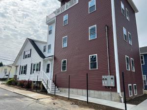 a large red building with a white house at Hideaway Private Studio in Providence