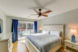 a bedroom with a bed and a ceiling fan at Private Dock, Hot Tub Waterfront Ocean Pines Home in Ocean Pines