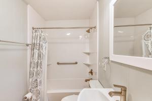 a white bathroom with a sink and a shower at Private Dock, Hot Tub Waterfront Ocean Pines Home in Ocean Pines +16 photos