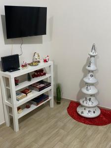 a living room with a christmas tree and a television at La Petite Maison in Naples
