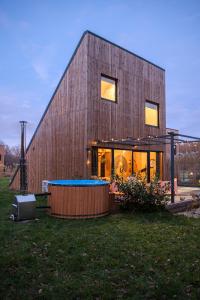 a wooden house with a pool in the yard at Zen Sasino in Sasino +56 photos