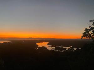 a sunset over a body of water at sunset at Minas Em Marambaia in Rio de Janeiro