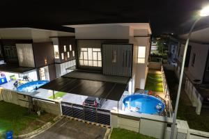 an aerial view of a house with a swimming pool at Desaru 918 Arcadia villa in Kangkar Chemaran