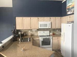 a kitchen with white appliances and a white refrigerator at Papa & Gigi's Lake Front Home in Port Clinton +8 photos