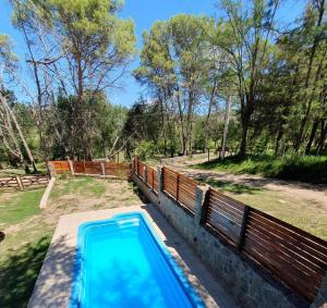 a swimming pool in the backyard of a house at Cabañas del Puente - Rio Grande San Luis in La Bajada