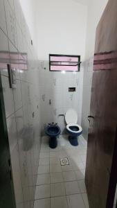 a bathroom with a toilet and a sink in it at Casa Cedro Azul II in Villa Carlos Paz