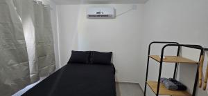 Ένα ή περισσότερα κρεβάτια σε δωμάτιο στο Apartamento Temporada Barra-Mar