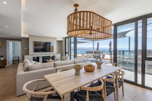 a living room with a couch and a table at Plett Quarter Apartments in Plettenberg Bay