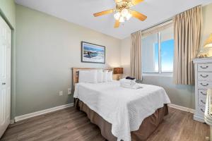a bedroom with a bed and a ceiling fan at Beach Club B-1208 in Gulf Highlands