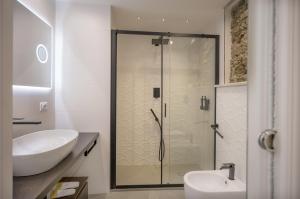 a bathroom with a glass shower and a sink at Taormina charming rooms in Taormina +50 photos