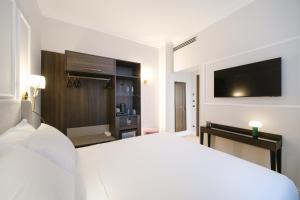 Postel nebo postele na pokoji v ubytování BH Hotel