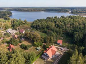 an aerial view of a house and a lake at Pensjonat Jutrzenka in Spychowo