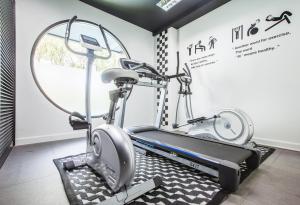 a gym with two ellipticals and a treadmill at Blu Monkey Hub and Hotel Phuket Town- Free All Day Coworking space in Phuket Town