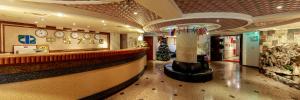 a restaurant with a christmas tree in the middle of a lobby at Chungli Business Hotel in Zhongli