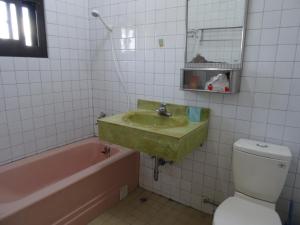 La salle de bains est pourvue d'un lavabo, d'une baignoire et de toilettes. dans l'établissement Hoin 4, à Xigang