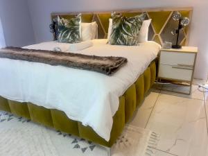 a bedroom with a large bed with a wooden headboard at Grace Boutique Guest House in Manamakgoteng